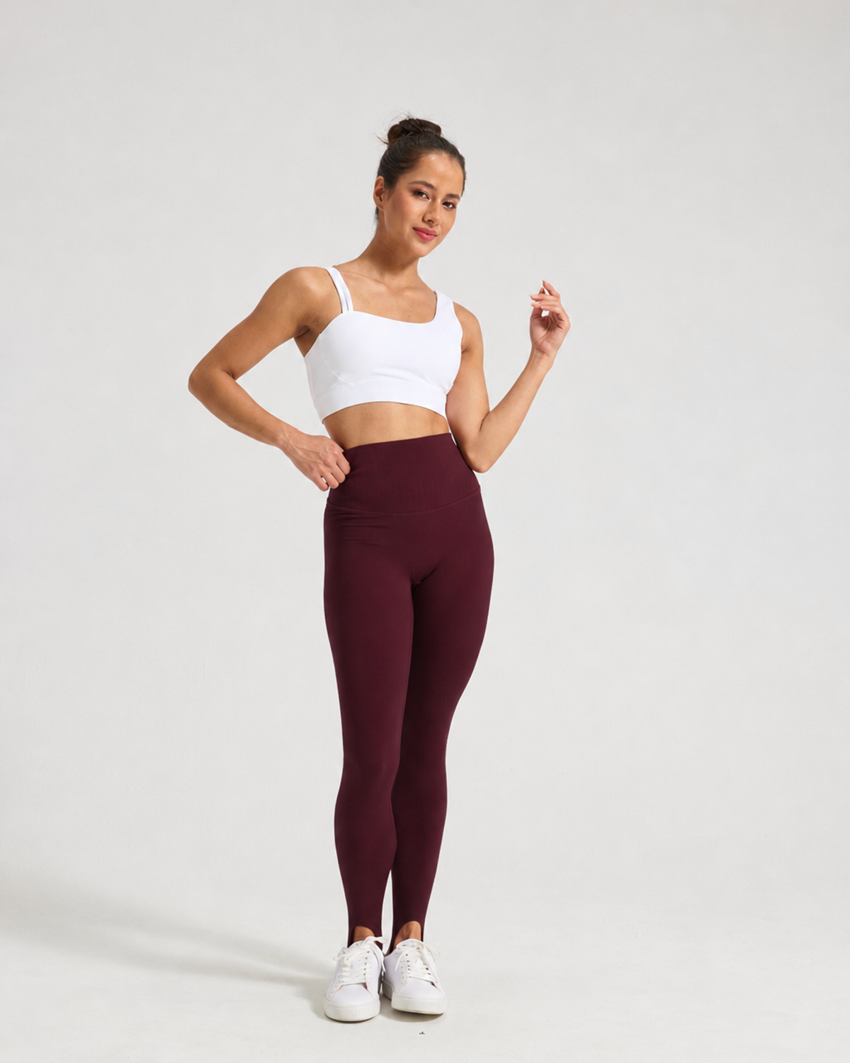 Model wearing Angola Red Formwynn stirrup leggings with a white top and trainers