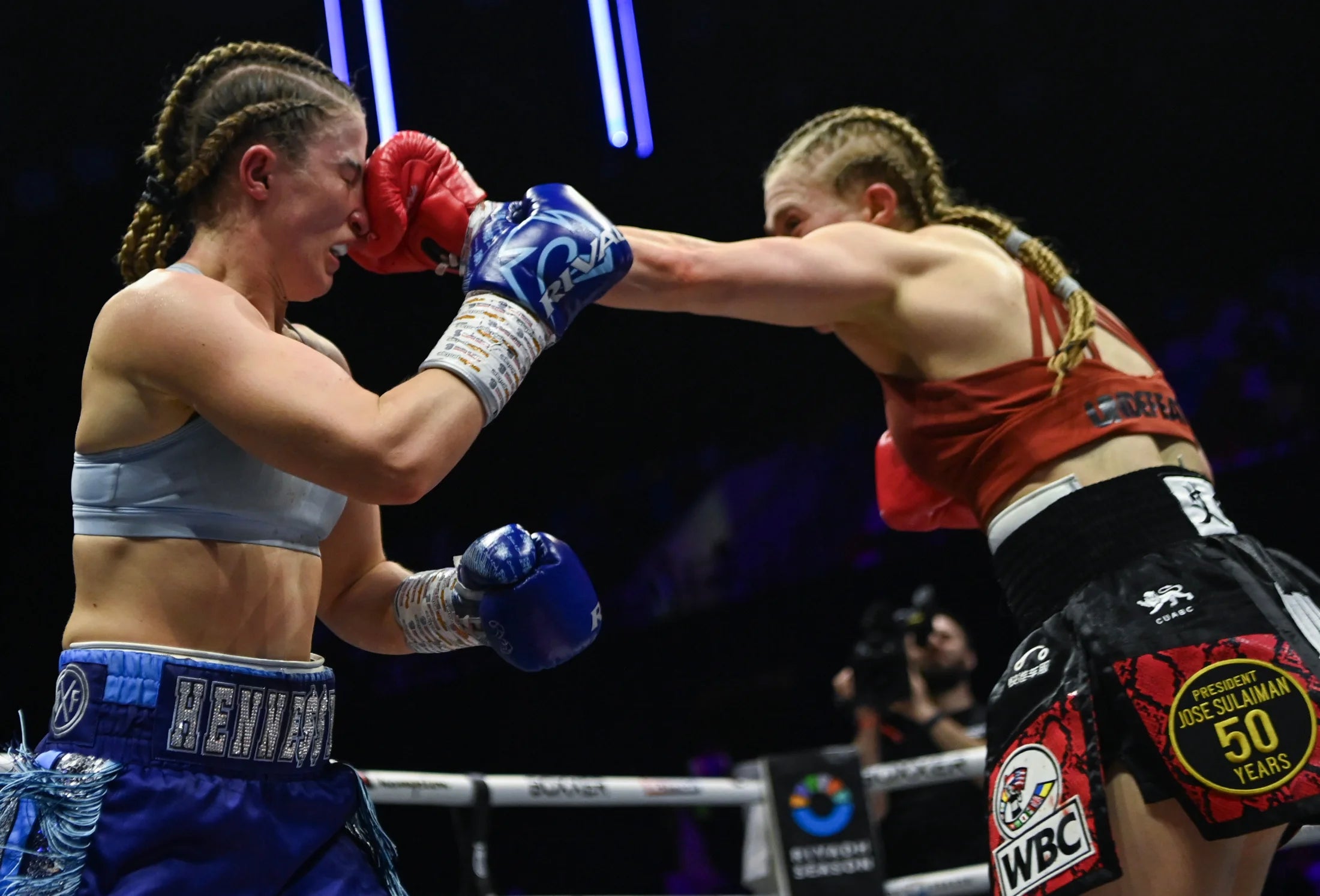 Ellie Bouttell exchanging punches during a professional boxing match