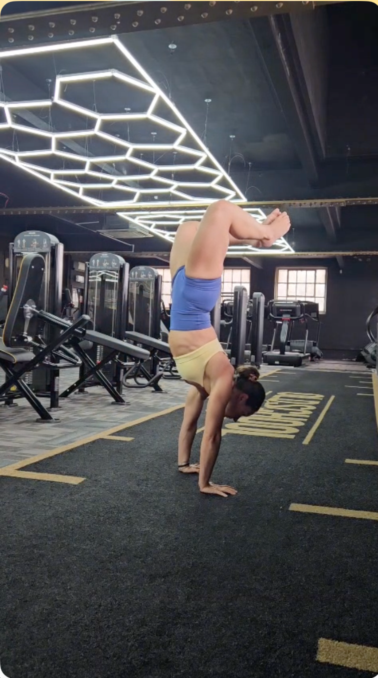 Athlete balancing in a handstand in Coastal Blue shorts